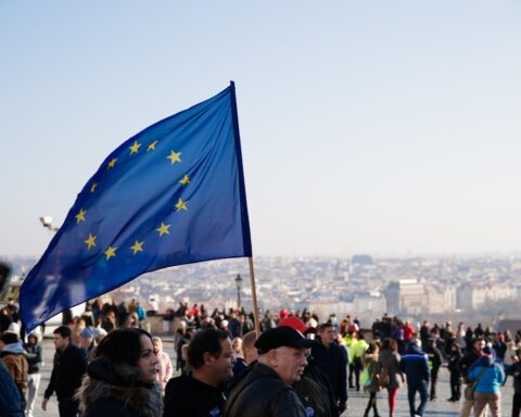 people on street with european union flag
